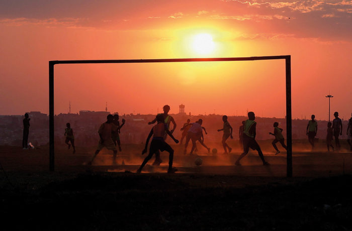 Boys playing soccer in South Africa.