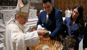 Pope baptizes a child on January 11, 2026.