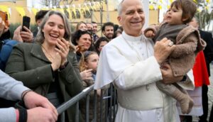Pope holding child in Rome, March 2026.
