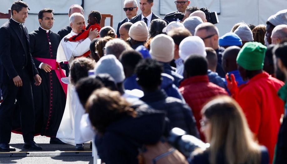 The Pope with migrants, holding a child in his arms, in Tenerife, Spain.